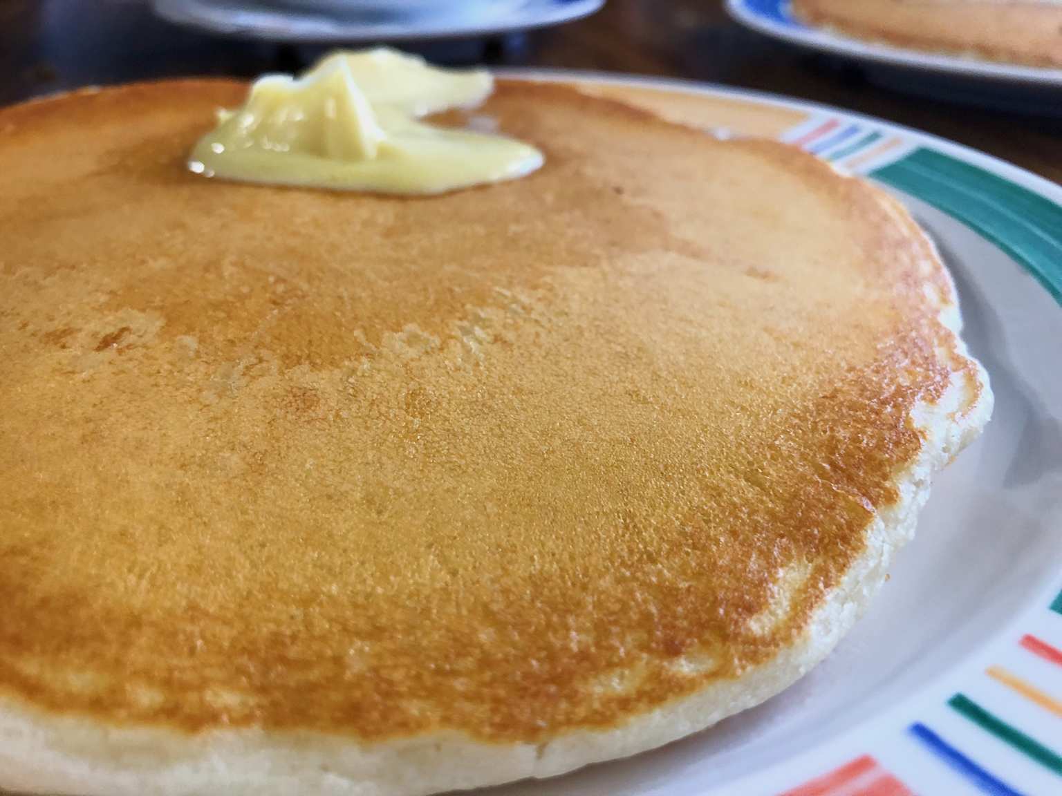 Golden brown pancake with butter at a classic Maui diner showcasing local breakfast flavors