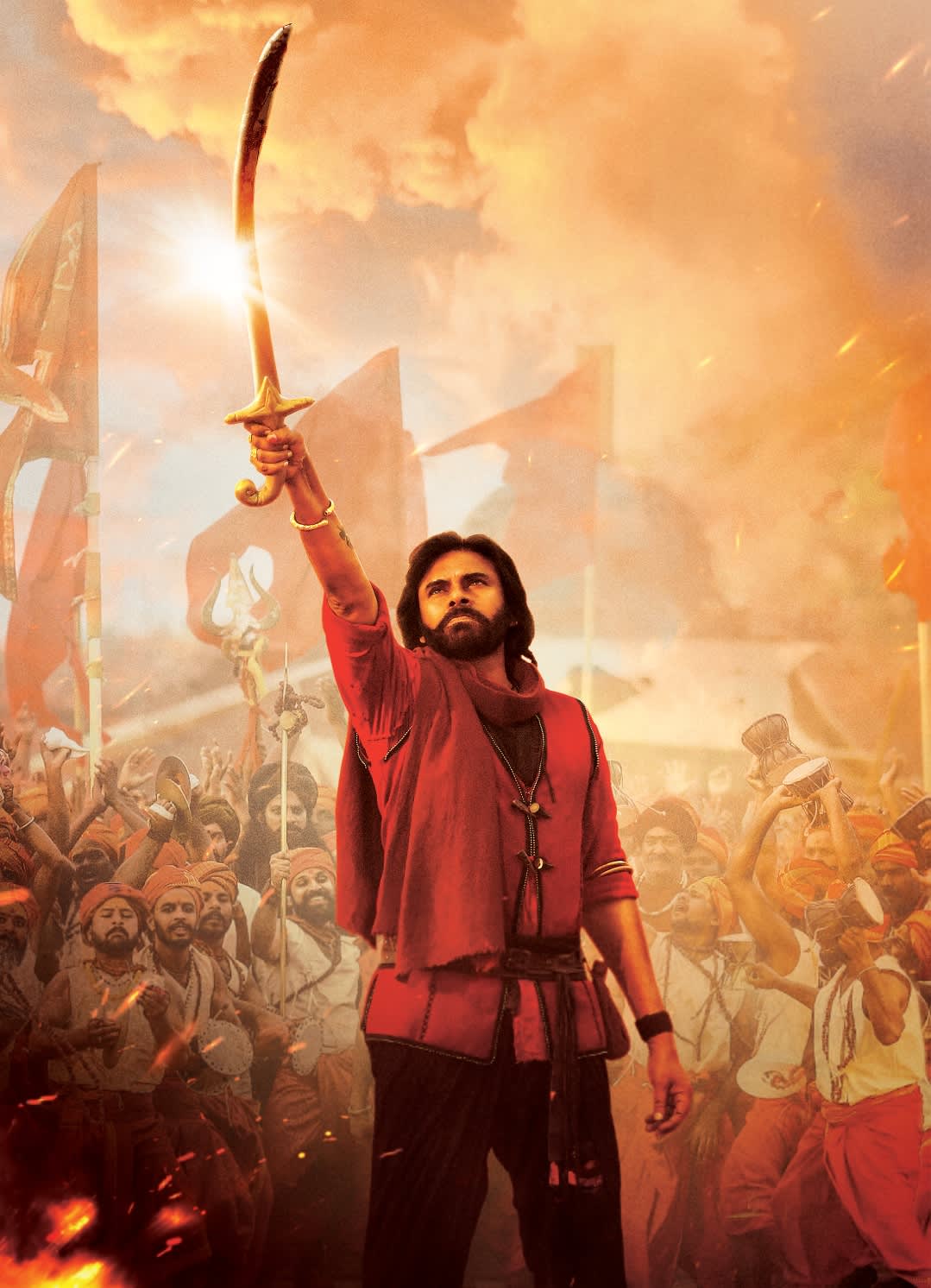 Pawan Kalyan as Hari Hara Veera Mallu holding a curved sword in warrior costume amid an enthusiastic crowd