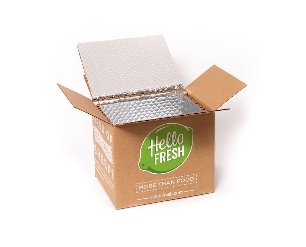 Open HelloFresh meal kit delivery box with insulated lining for food freshness.