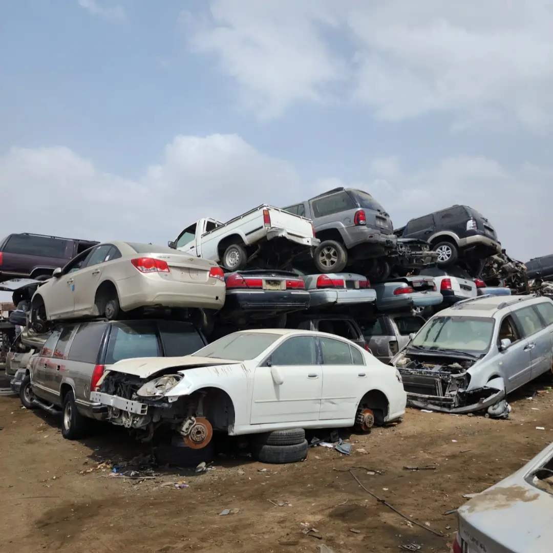 Many scrapped cars stacked in a scrapyard representing car dismantling and used parts availability in Buraidah