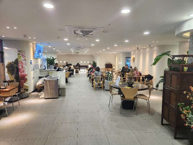 Interior of 양산국밥 restaurant near Busan Station showing a clean and modern dining area with customers.