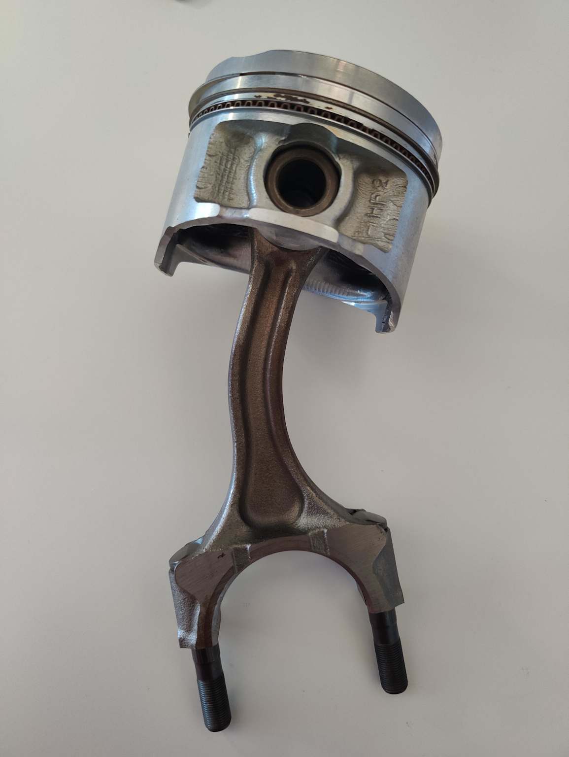 Bent piston rod showing mechanical damage caused by engine hydrolock