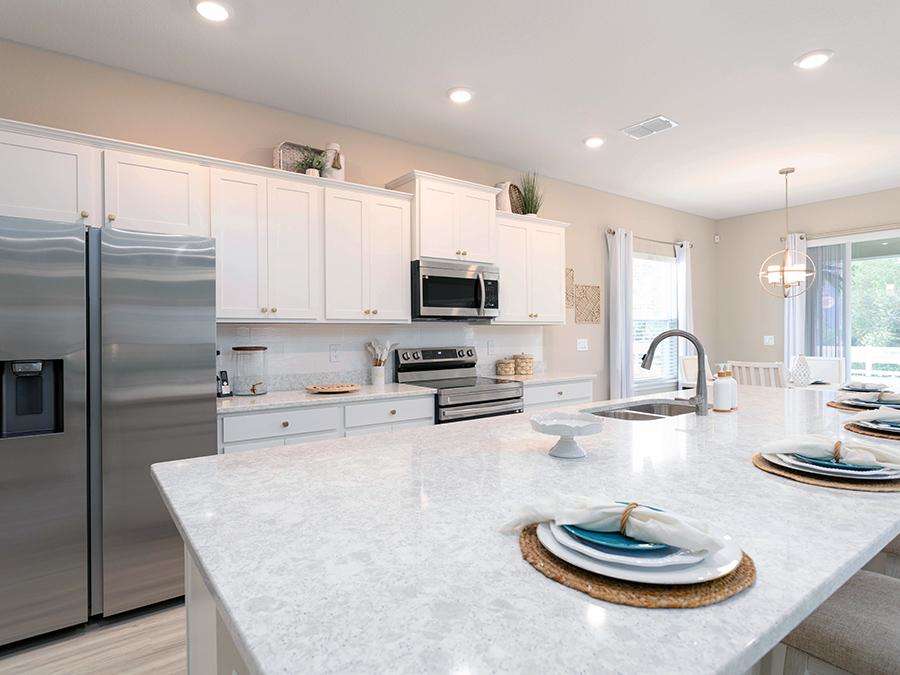 A modern kitchen featuring a large quartz countertop island