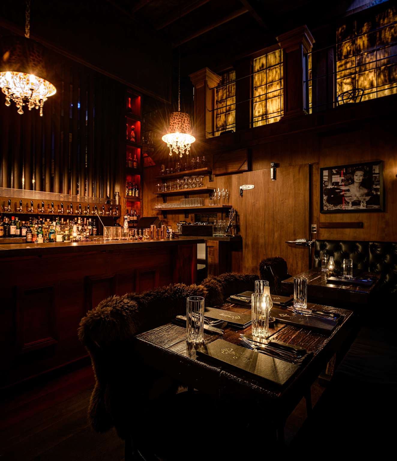 The interior of Gaslamp Kailua steakhouse speakeasy in Hawaii exudes warm vintage charm and intimate dining ambiance