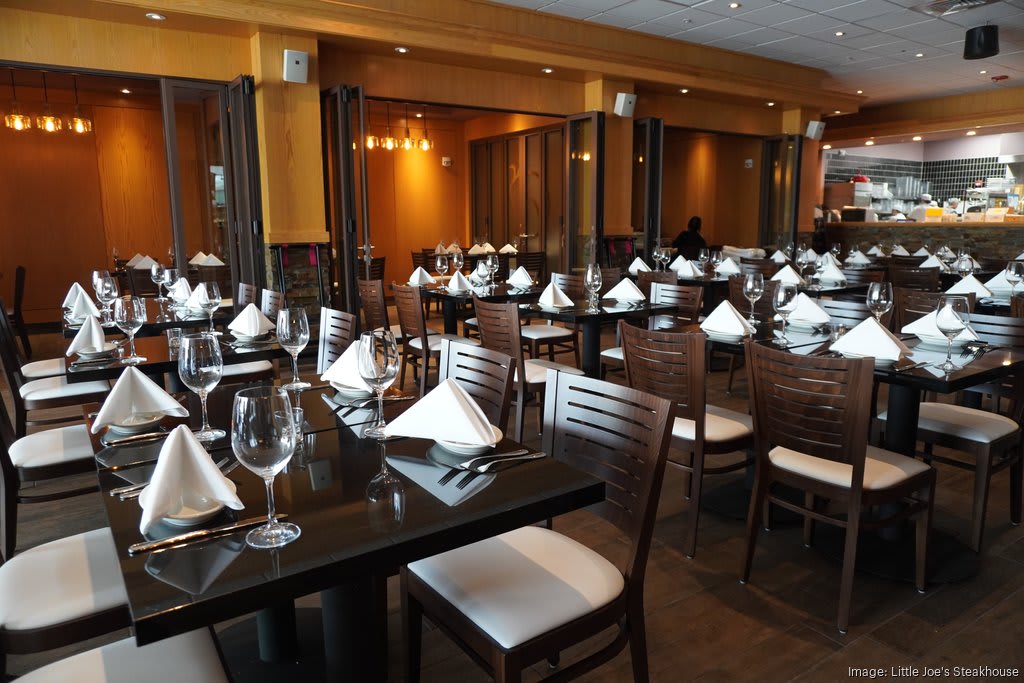Interior of Little Joe's Steakhouse in Hawaii featuring formally set tables and a warm, inviting ambiance