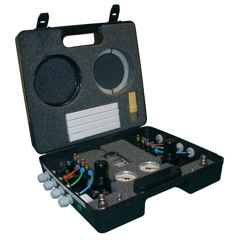 A portable compressed air purity test kit with pressure gauges and wiring inside a protective carrying case