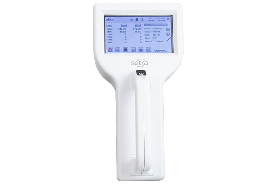Setra Laser Particle Counter showing real-time particle count readings and testing parameters for compressed air analysis