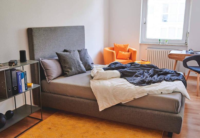 Modern student apartment bedroom in Germany with functional furniture and cozy atmosphere