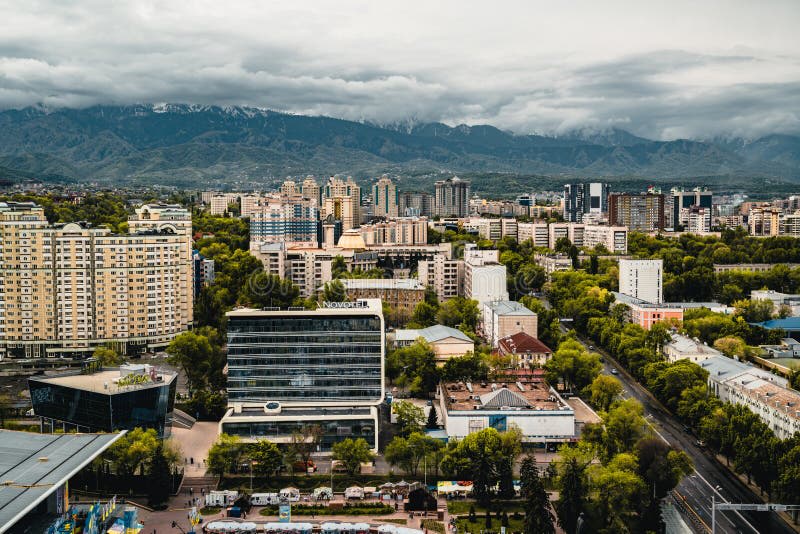 Almaty city skyline with the snow-capped Tian Shan mountains in the background showcasing the blend of urban life and stunning natural landscapes in Kazakhstan