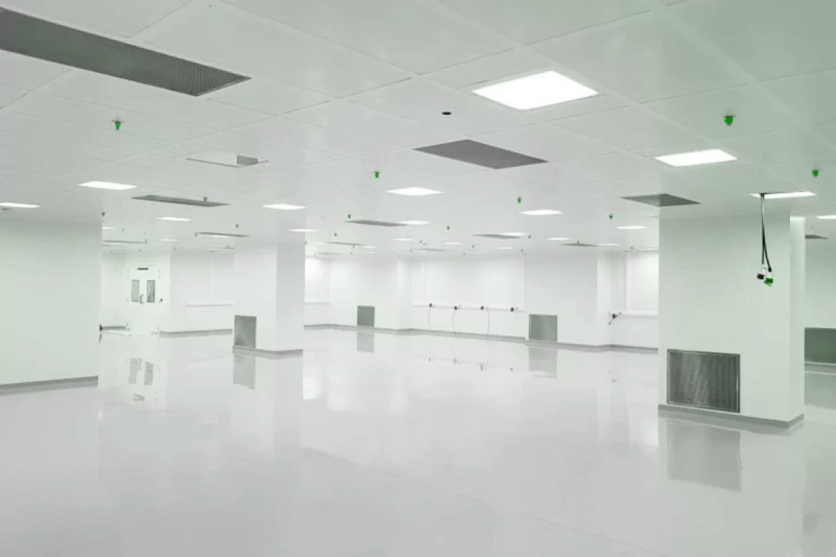 Industrial cleanroom interior illuminated by evenly distributed LED ceiling lights designed for contamination-controlled environments