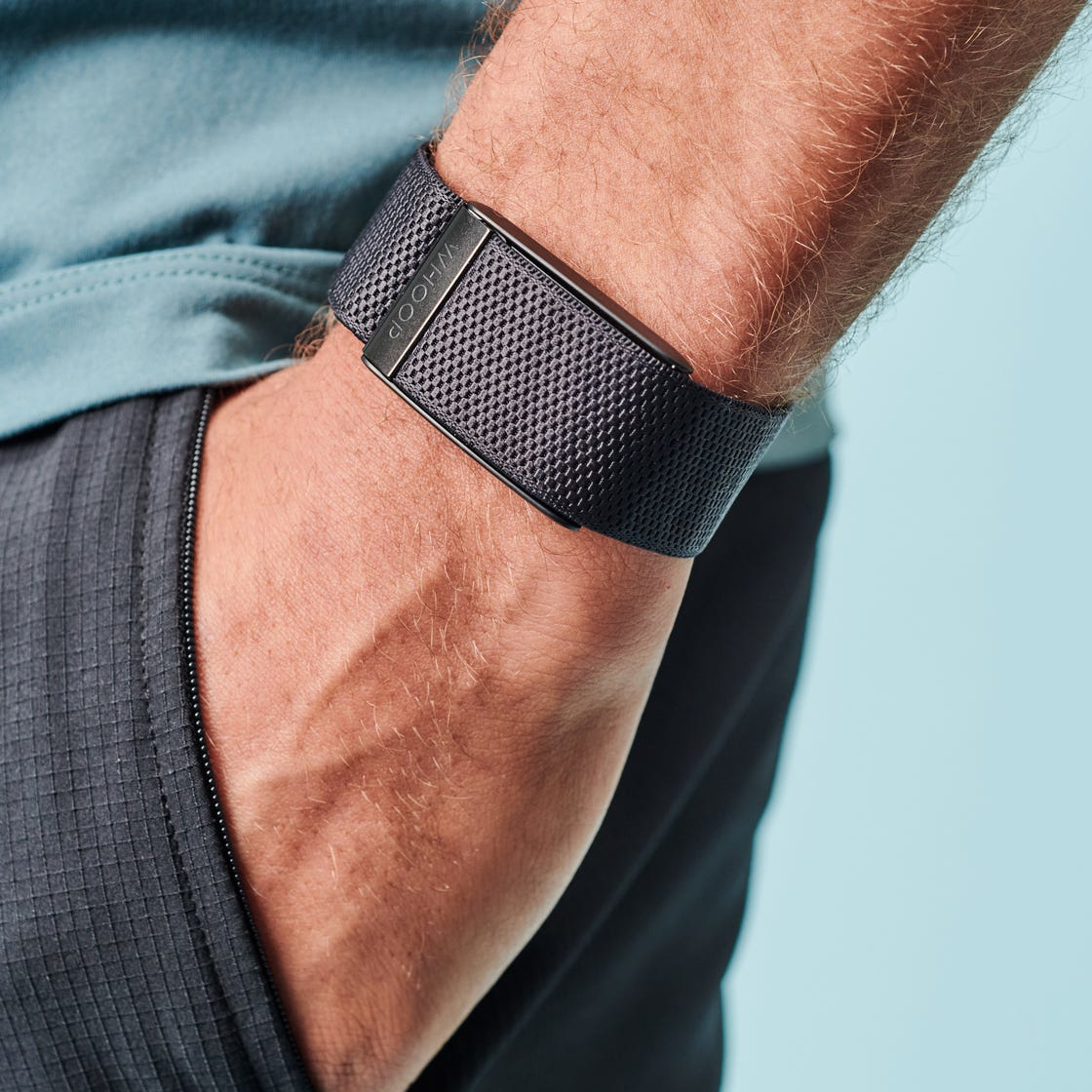 A close-up of a wrist wearing the WHOOP 4.0 fitness wearable, showcasing innovation in health monitoring technology