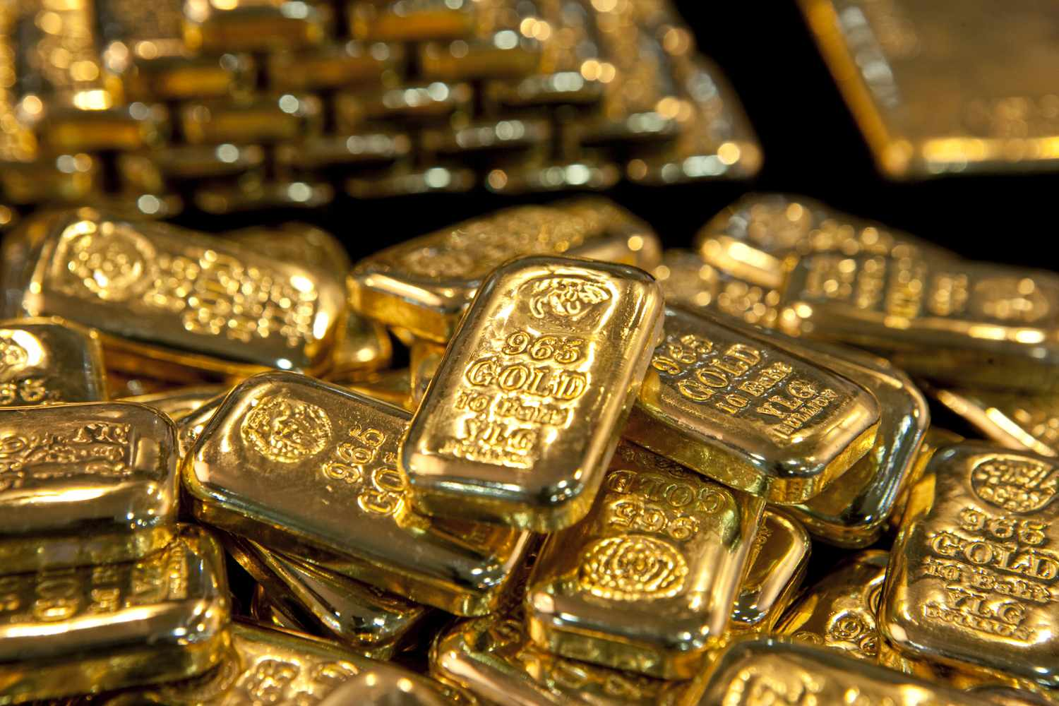 Shiny gold bars marked with purity and weight, symbolizing valuable investment assets