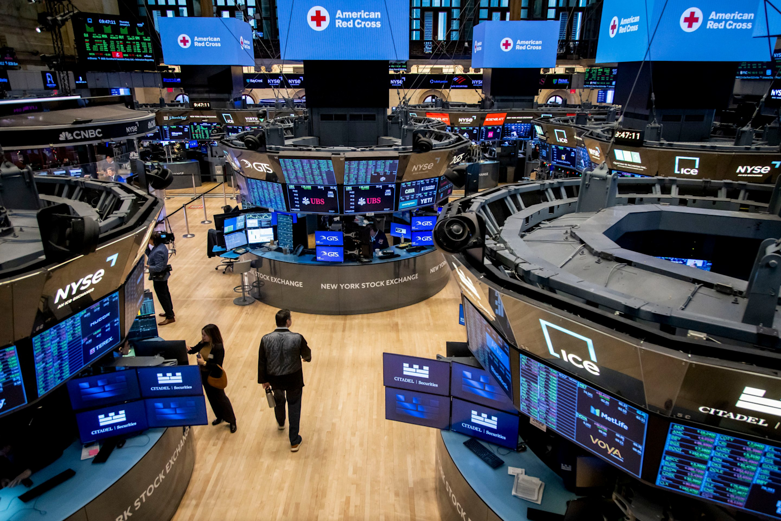 New York Stock Exchange trading floor displaying financial data, representing AI-driven job displacement on Wall Street