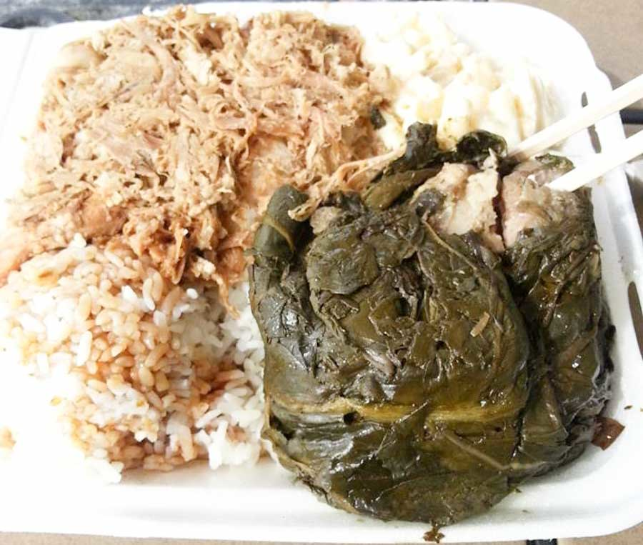 Traditional Hawaiian plate lunch with lau lau, kalua pork, rice, and macaroni salad