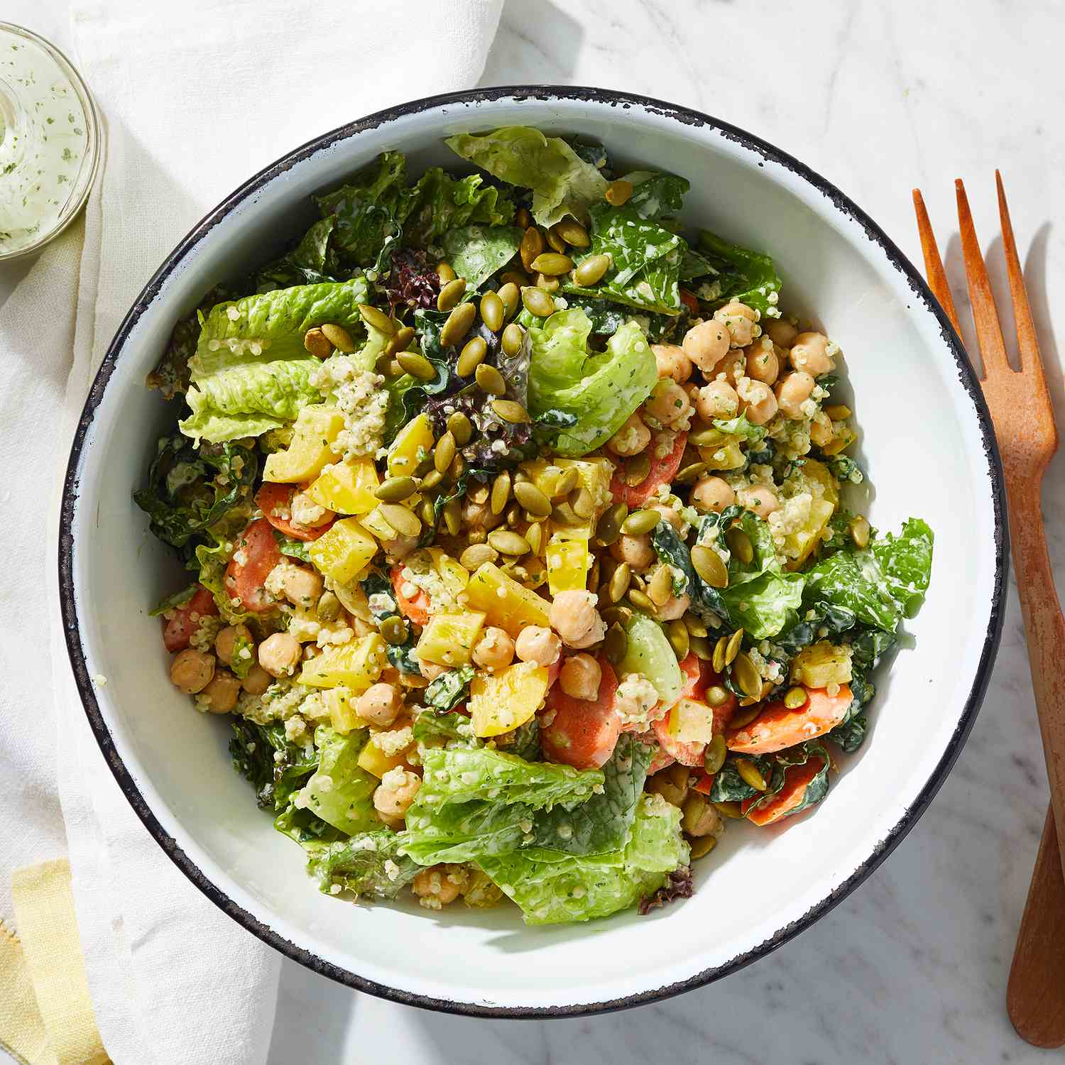 Fresh nutrient-dense salad with leafy greens, chickpeas, quinoa, and pumpkin seeds illustrating anti-inflammatory Mediterranean diet benefits clean eating