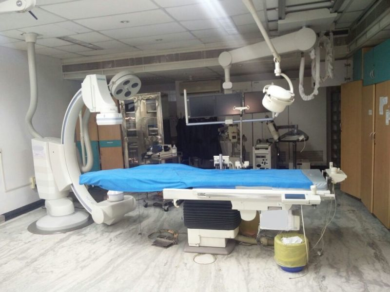 Modern cardiac catheterization lab with angiography equipment and procedural setup in a cardiac care unit