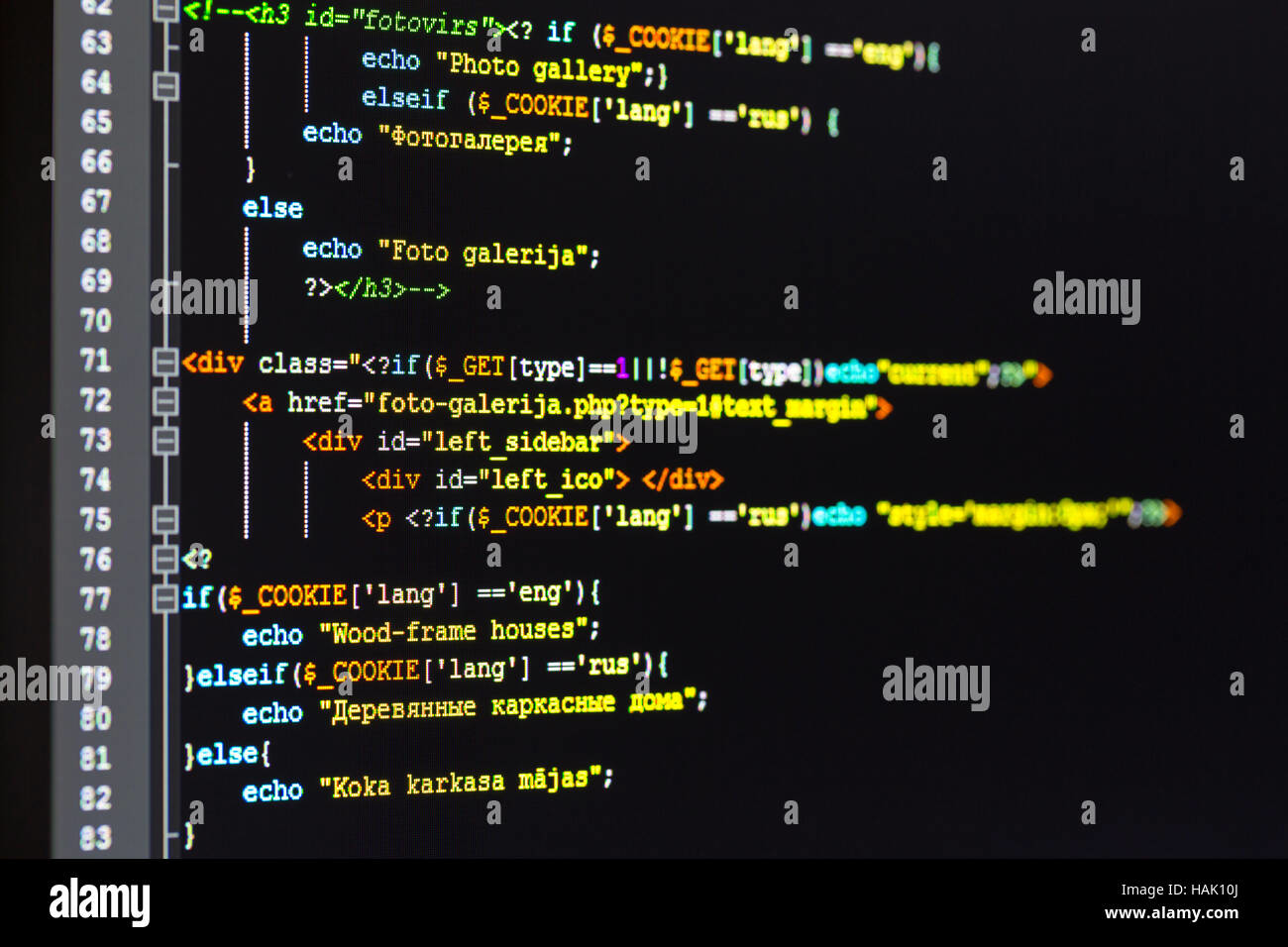 Close-up of a programmer's screen showing multi-language PHP coding with syntax highlighting in a dark-themed code editor