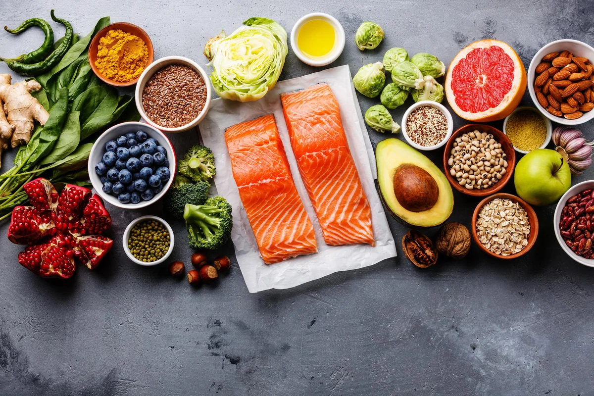 Anti-inflammatory and nutrient-rich foods like salmon, nuts, berries, and vegetables that support faster recovery from sports injuries