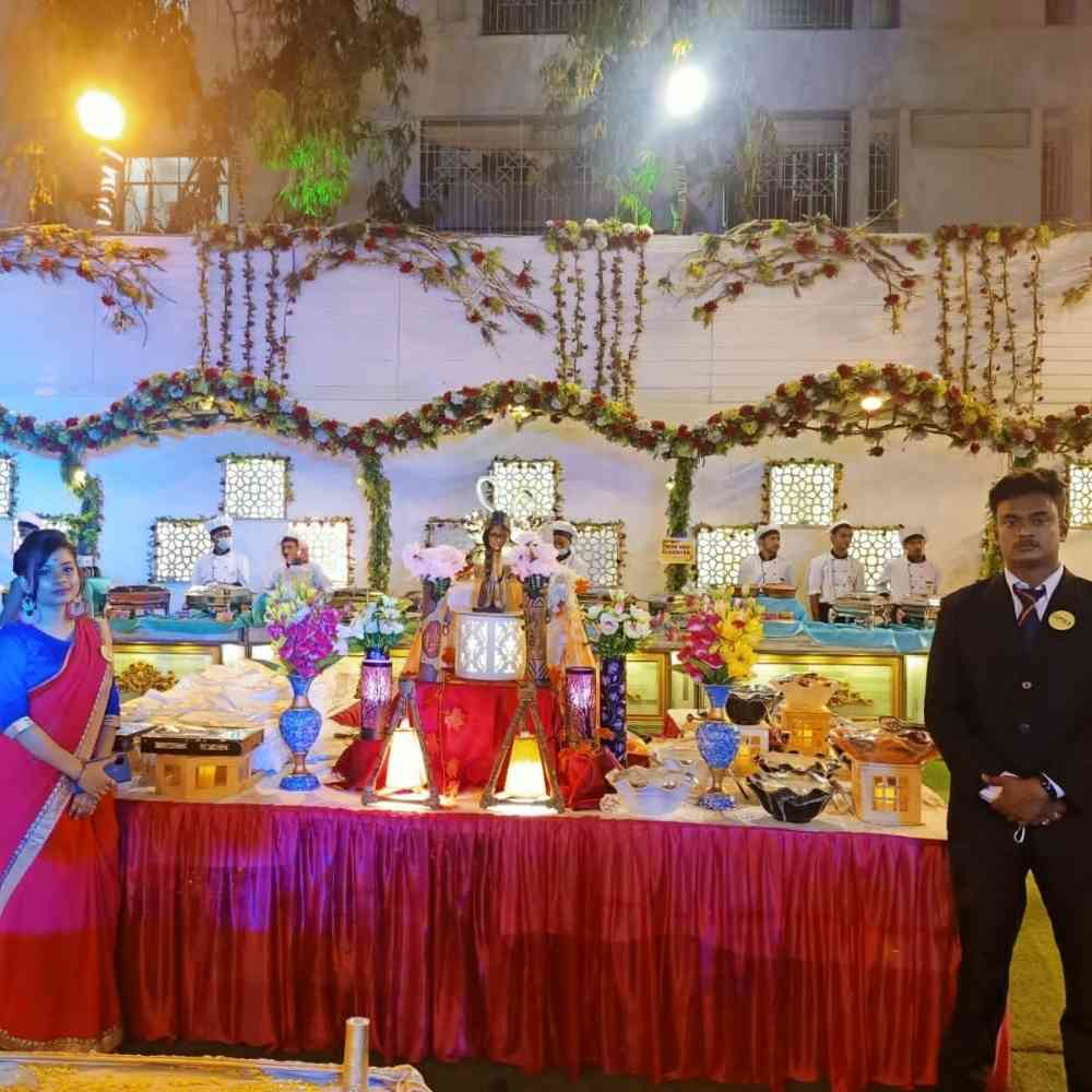 Professional wedding catering setup with decorated buffet table and chefs ready to serve