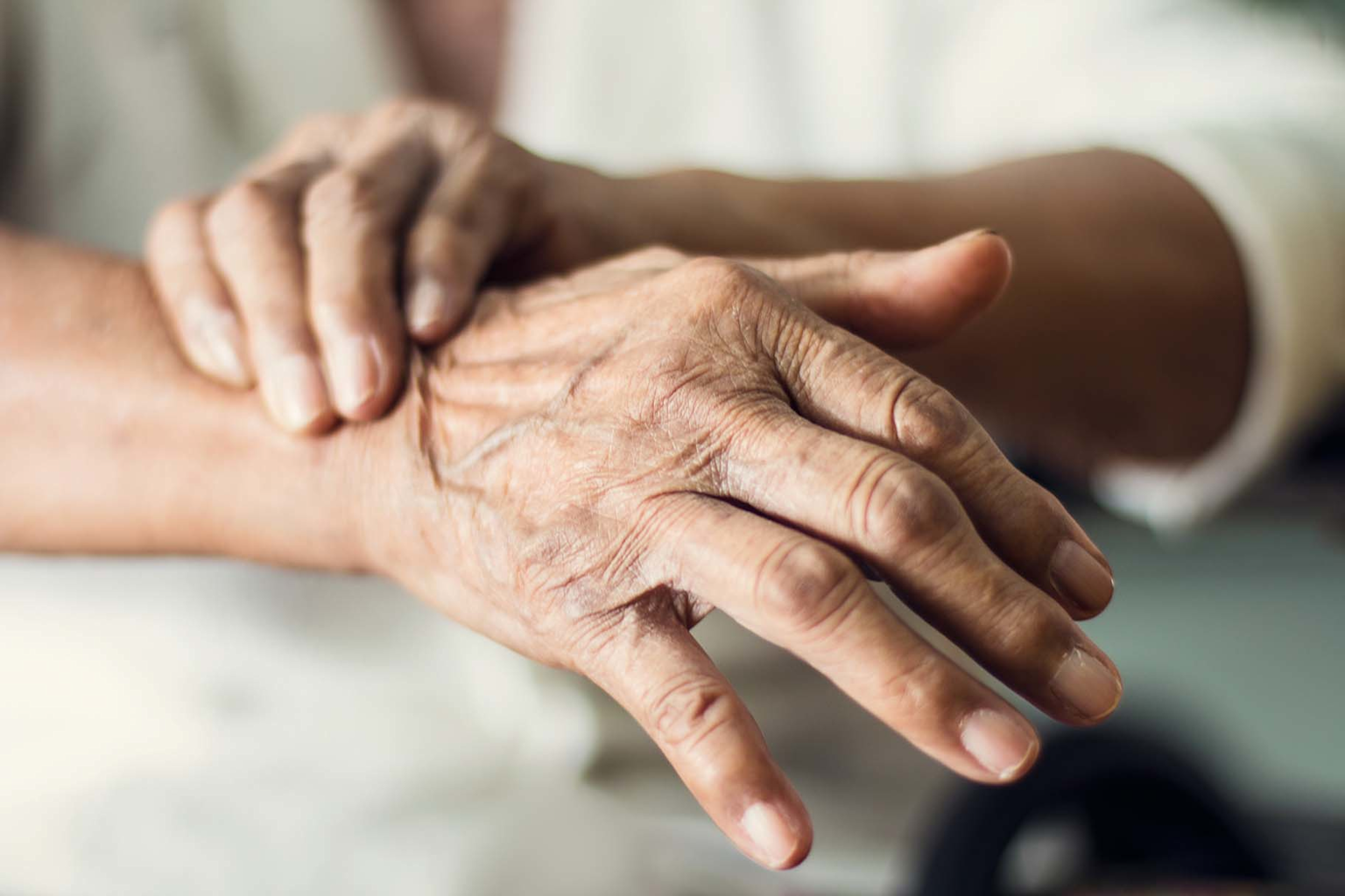 Close-up of hands showing rigidity and tremor symptoms of Parkinson's disease