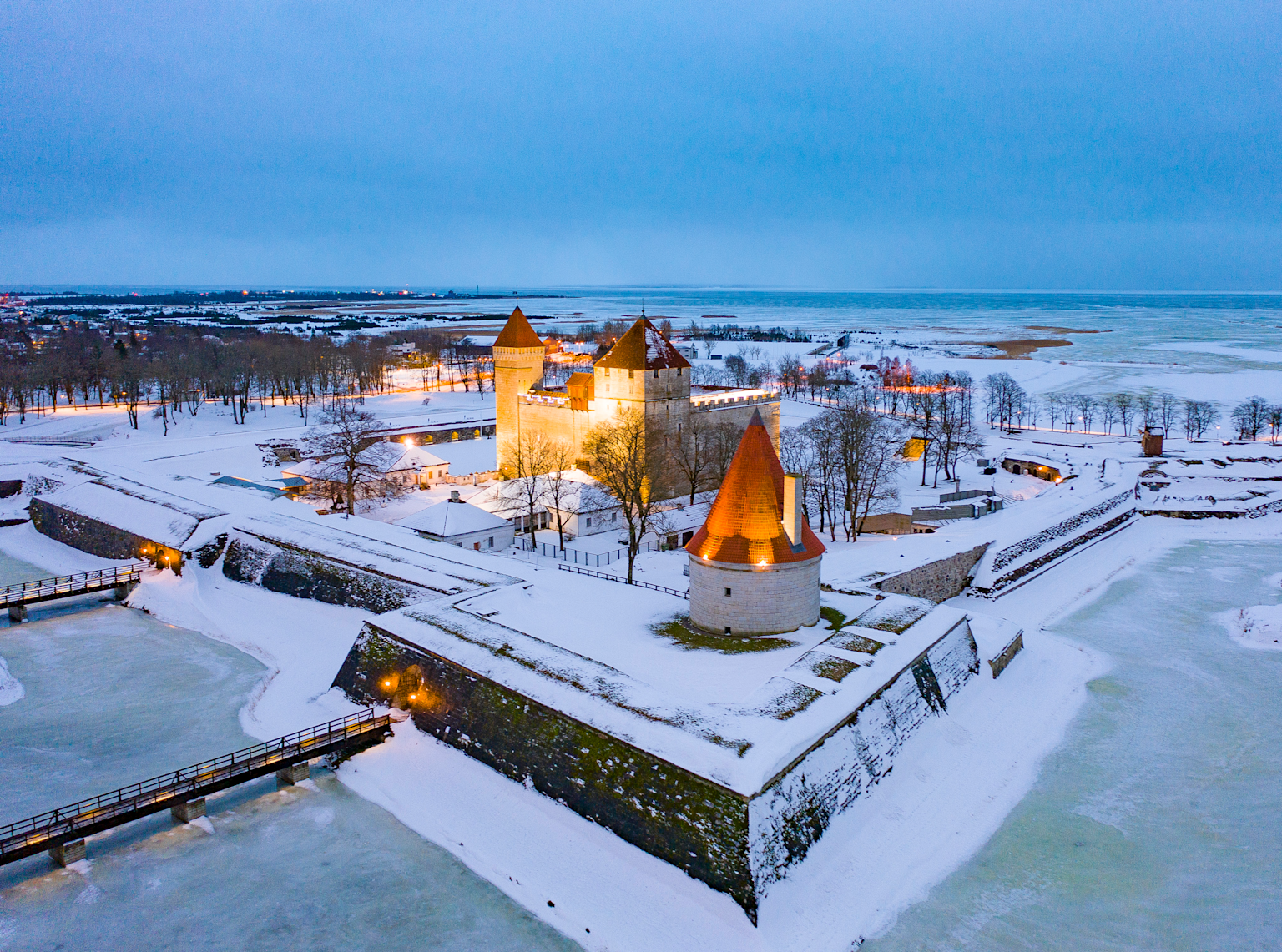 Kuressaare Castle on Saaremaa Island, Estonia, showcasing its medieval architecture set amidst a snowy winter landscape near the Baltic Sea