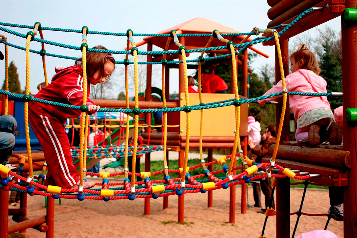 Children playing on rope climbing bridge