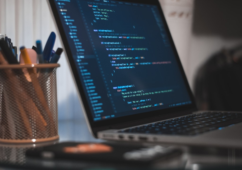 Laptop screen showing code in a development environment, representing remote software development work