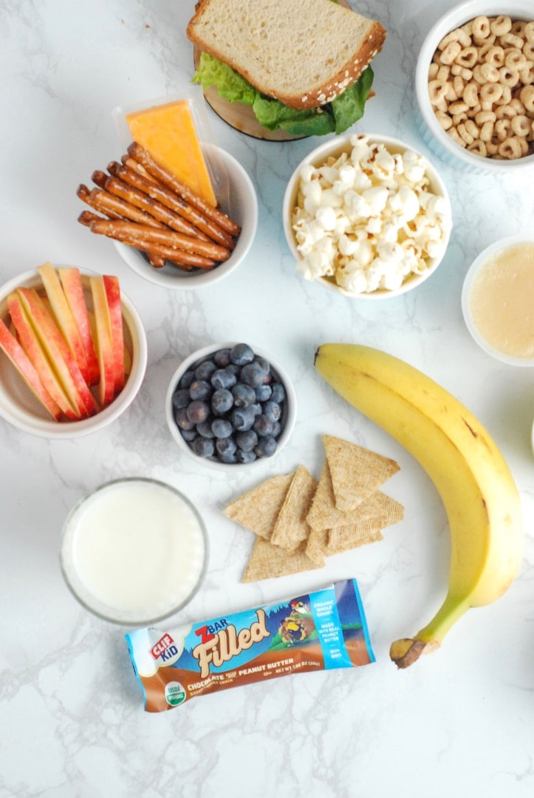A selection of balanced and nutritious snacks for active teenagers, including fruits, grains, protein, and energy bars