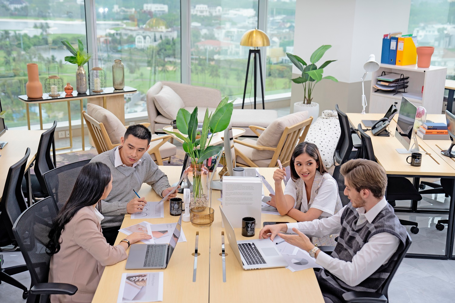 Diverse professionals brainstorming collaboratively in a modern office to enhance productivity and creativity