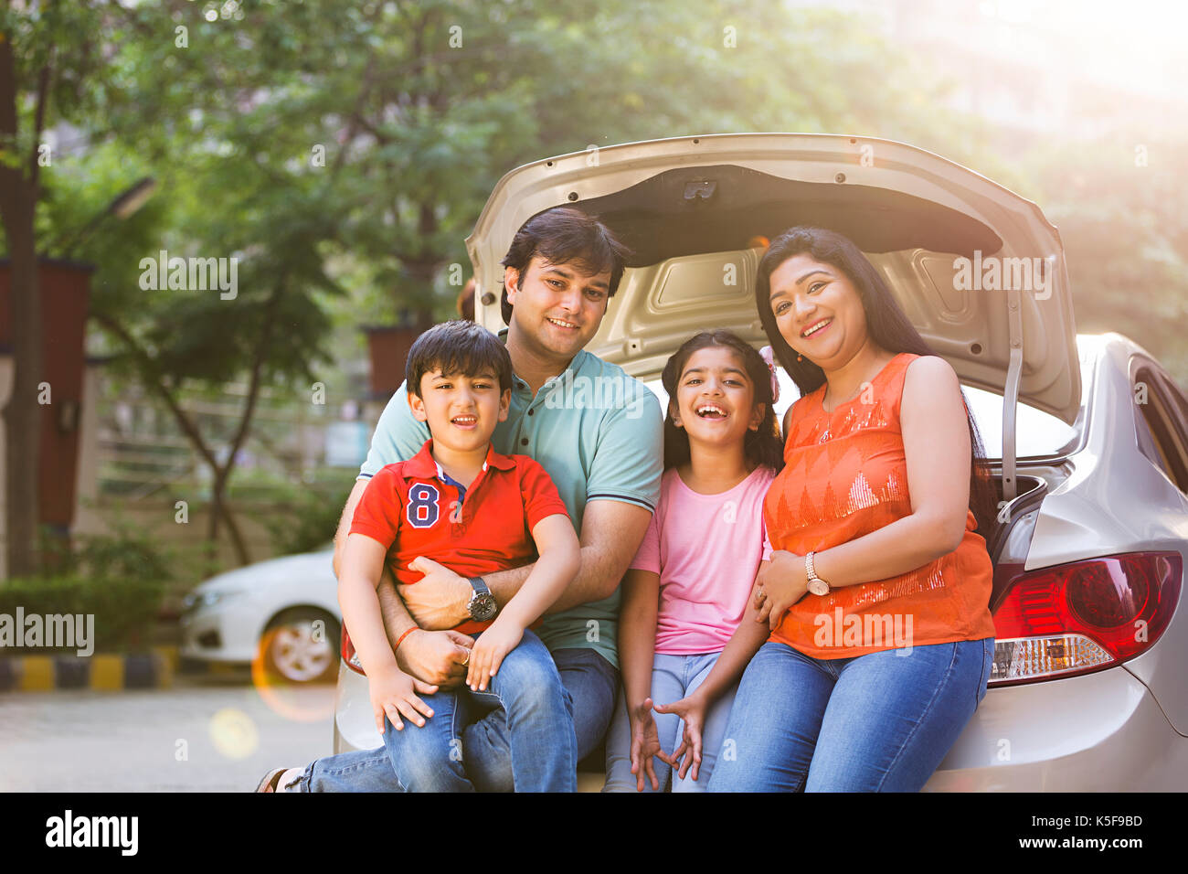 Happy Indian family at car trunk - Yuvansh Tour and Travel
