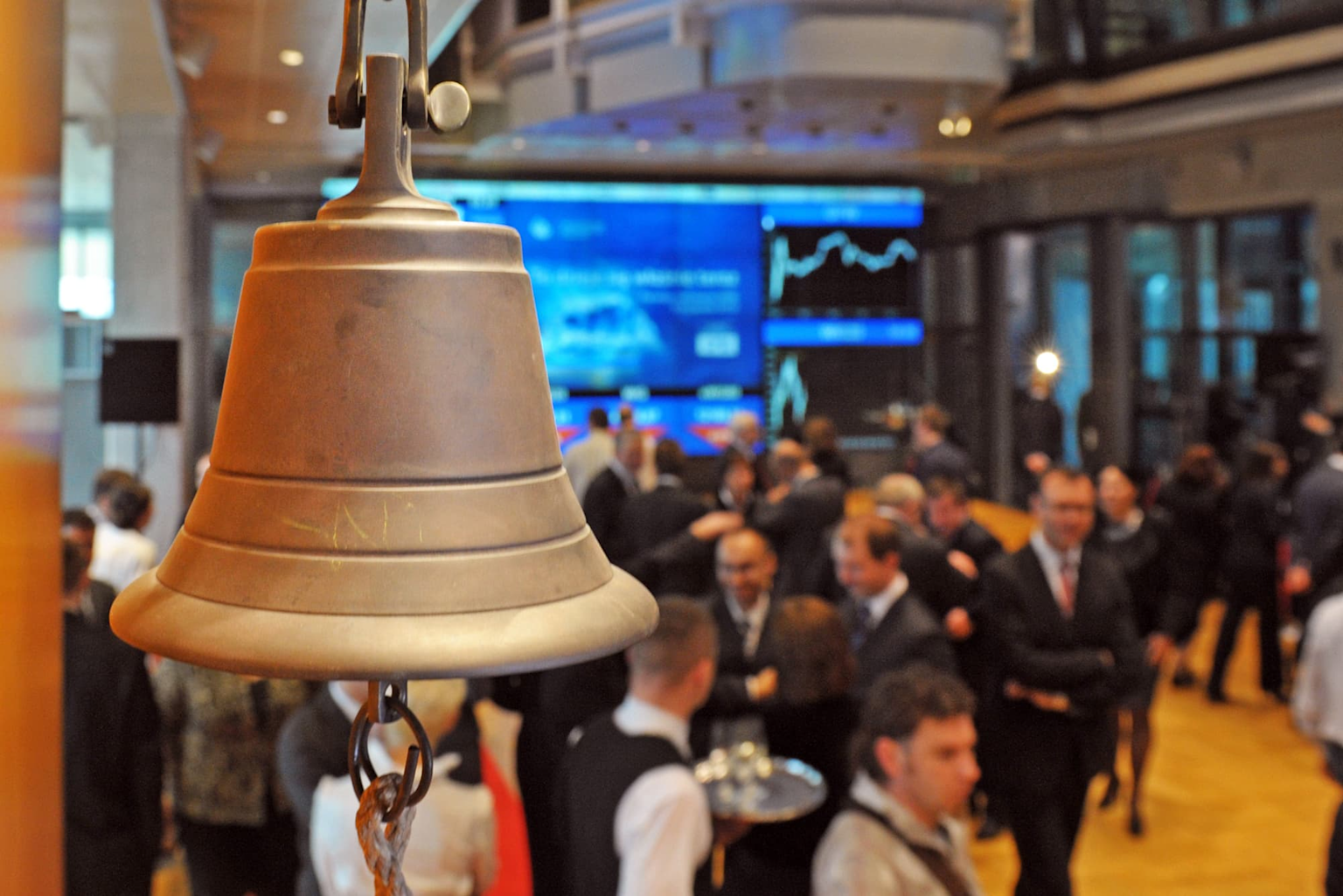 The opening bell at a stock exchange trading floor symbolizes the start of a trading session amid dynamic market activity