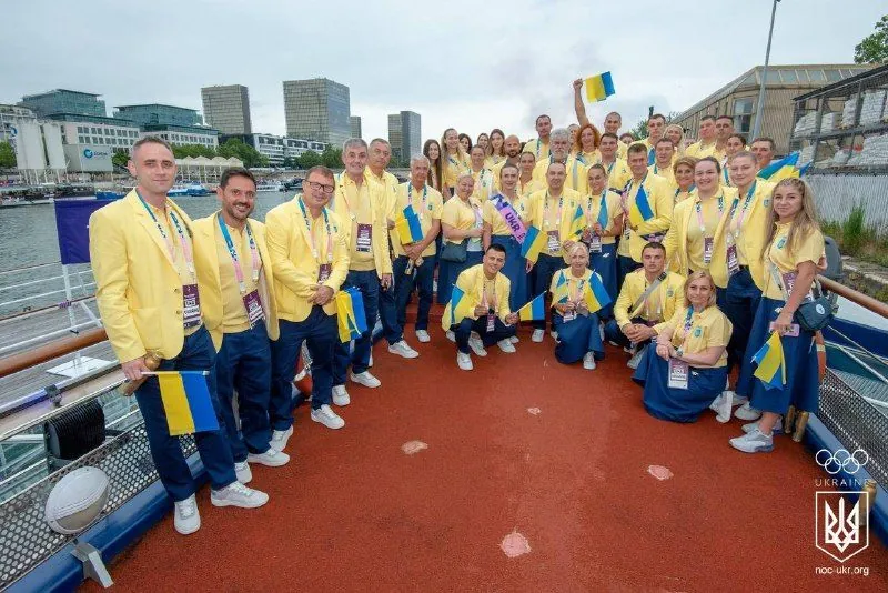 Ukrainian Olympic team posing together in official yellow and blue uniforms during the Olympic Games