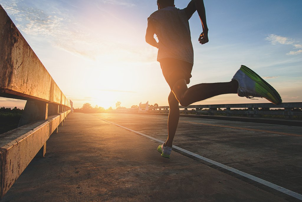 Runner training on an early morning during sunrise illustrating morning workout and chronotype relevance