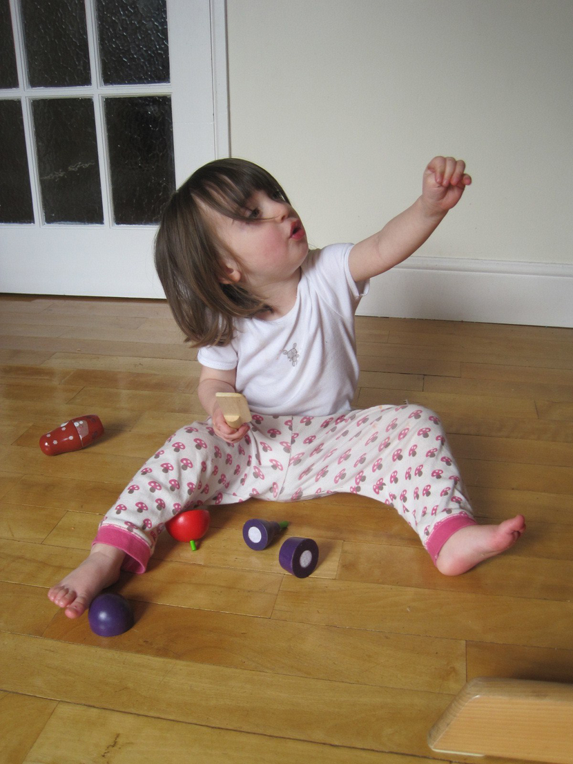 A young child engaging in play to develop early motor skills during sensitive periods of growth