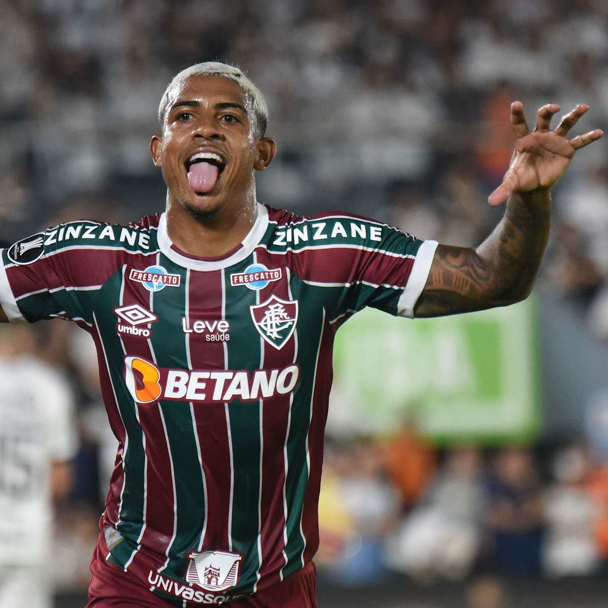 Fluminense FC player celebrating during a football match, wearing the team's branded jersey