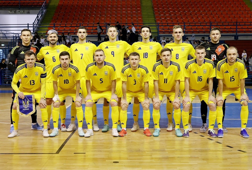 Ukrainian national futsal team posing for a group photo before a match indoors