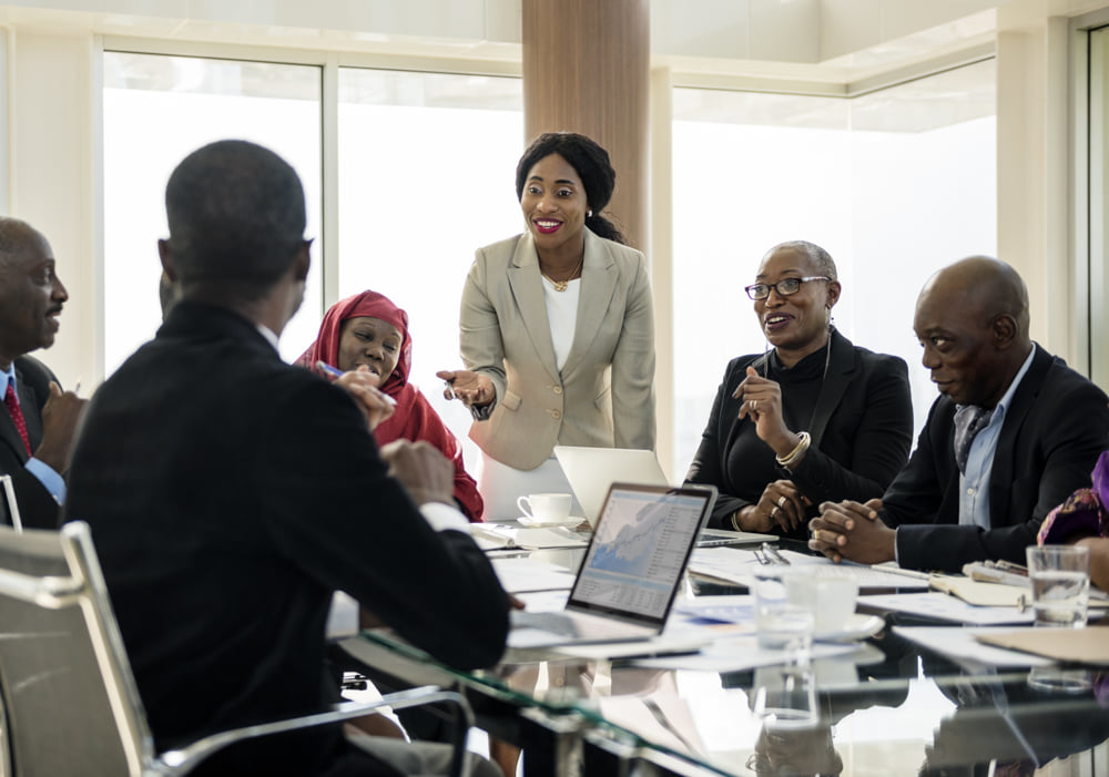 Corporate boardroom meeting led by a woman in a modern office, illustrating teamwork and professional collaboration