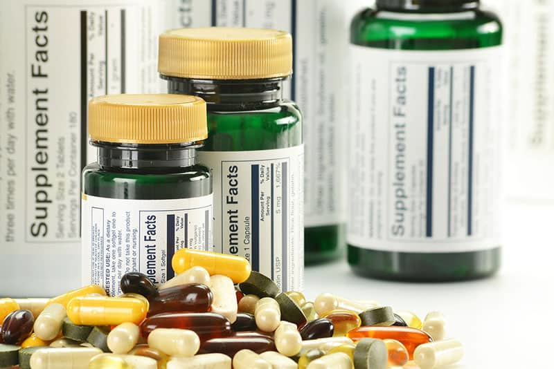 Various vitamin supplement bottles and capsules illustrating dietary supplements