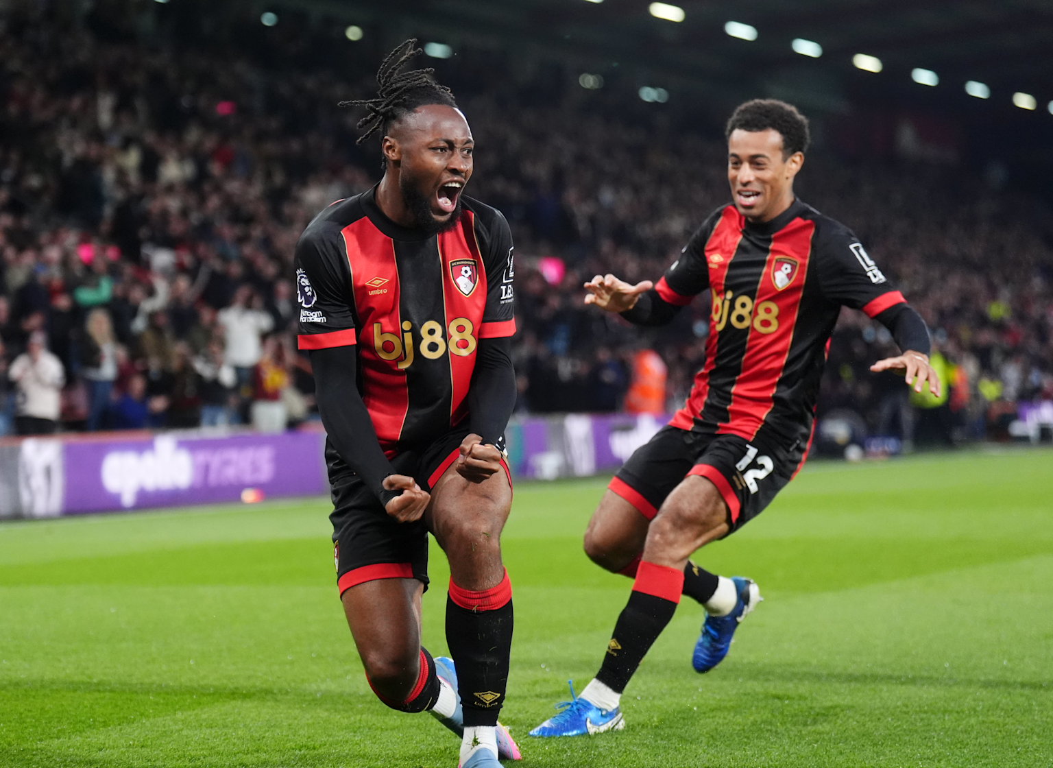 Bournemouth players celebrating a goal in a Premier League match, highlighting the team's strong performance and ambition