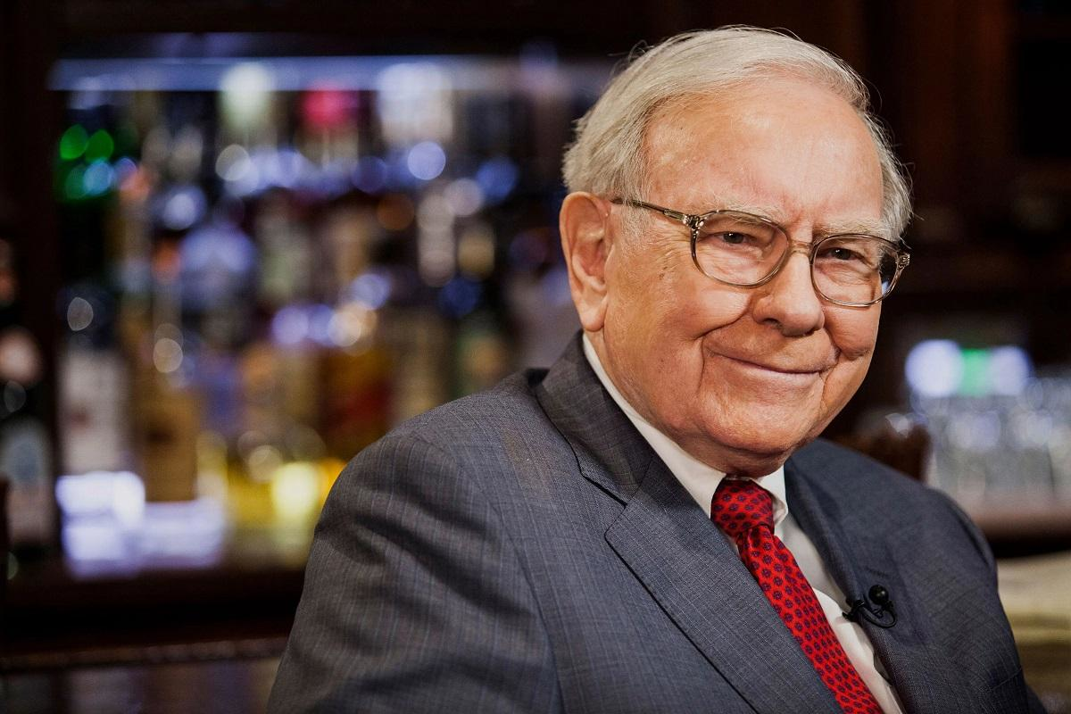 Warren Buffett smiling in a formal suit, symbolizing the renowned investment legend