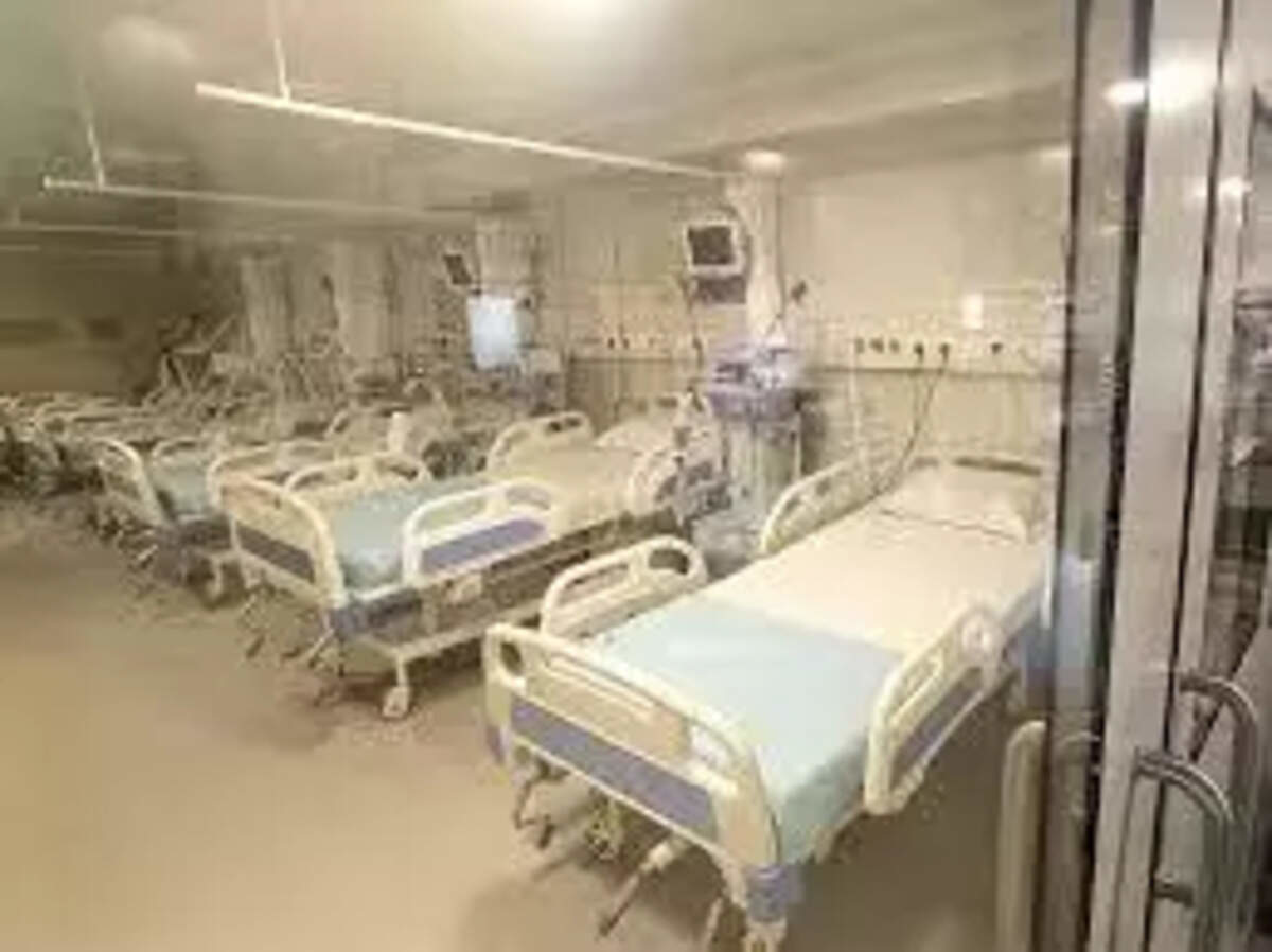Hospital ward with multiple beds and medical monitors, typical of a government hospital dialysis or treatment center