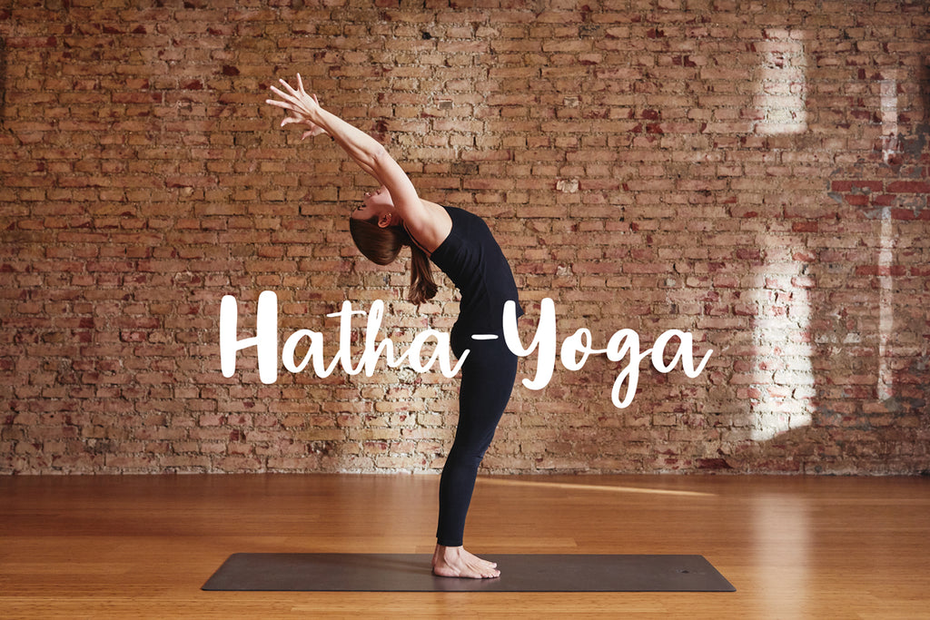 A woman practicing Hatha Yoga in a realistic indoor setting