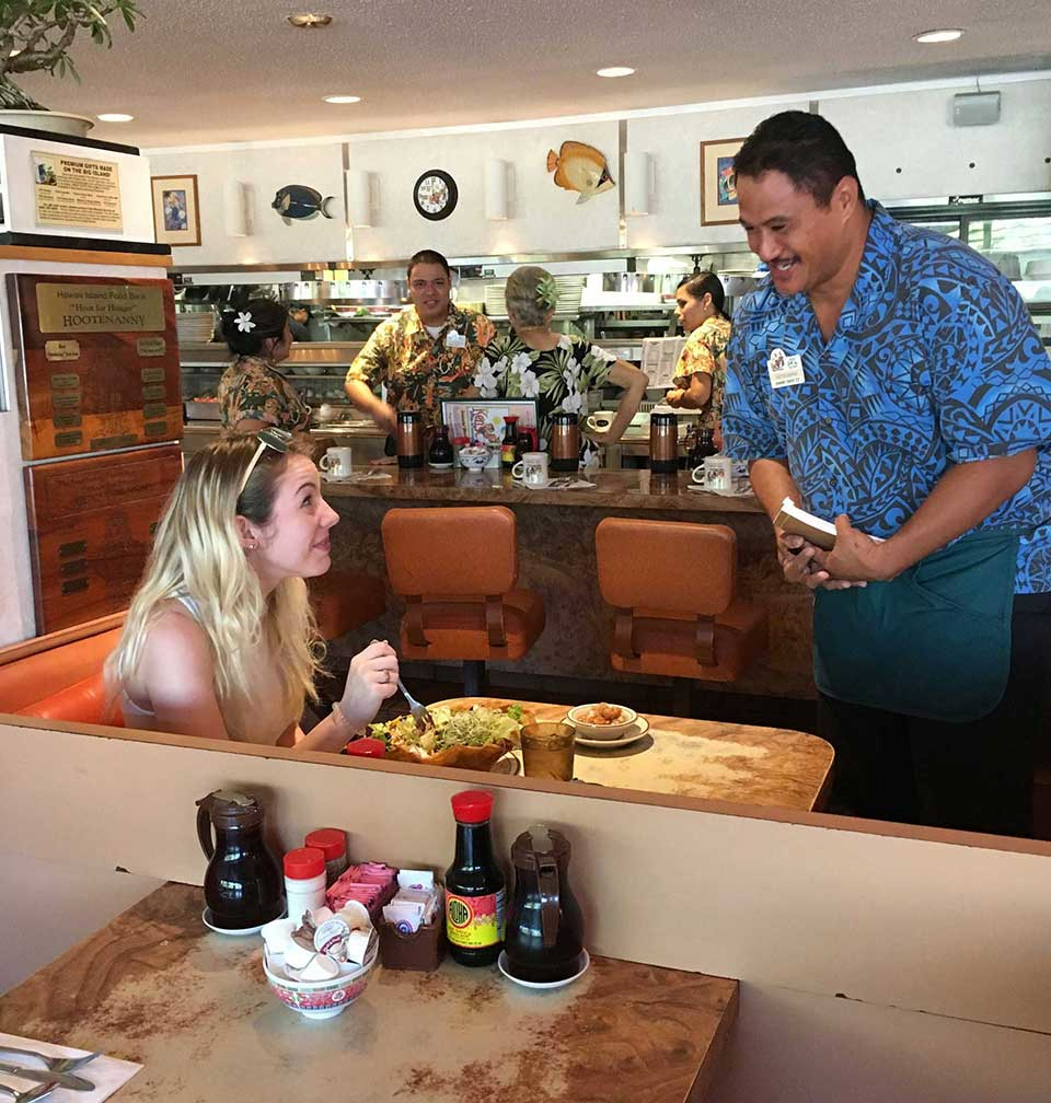 Inside Ken's House of Pancakes diner in Hilo showing friendly service and classic breakfast atmosphere