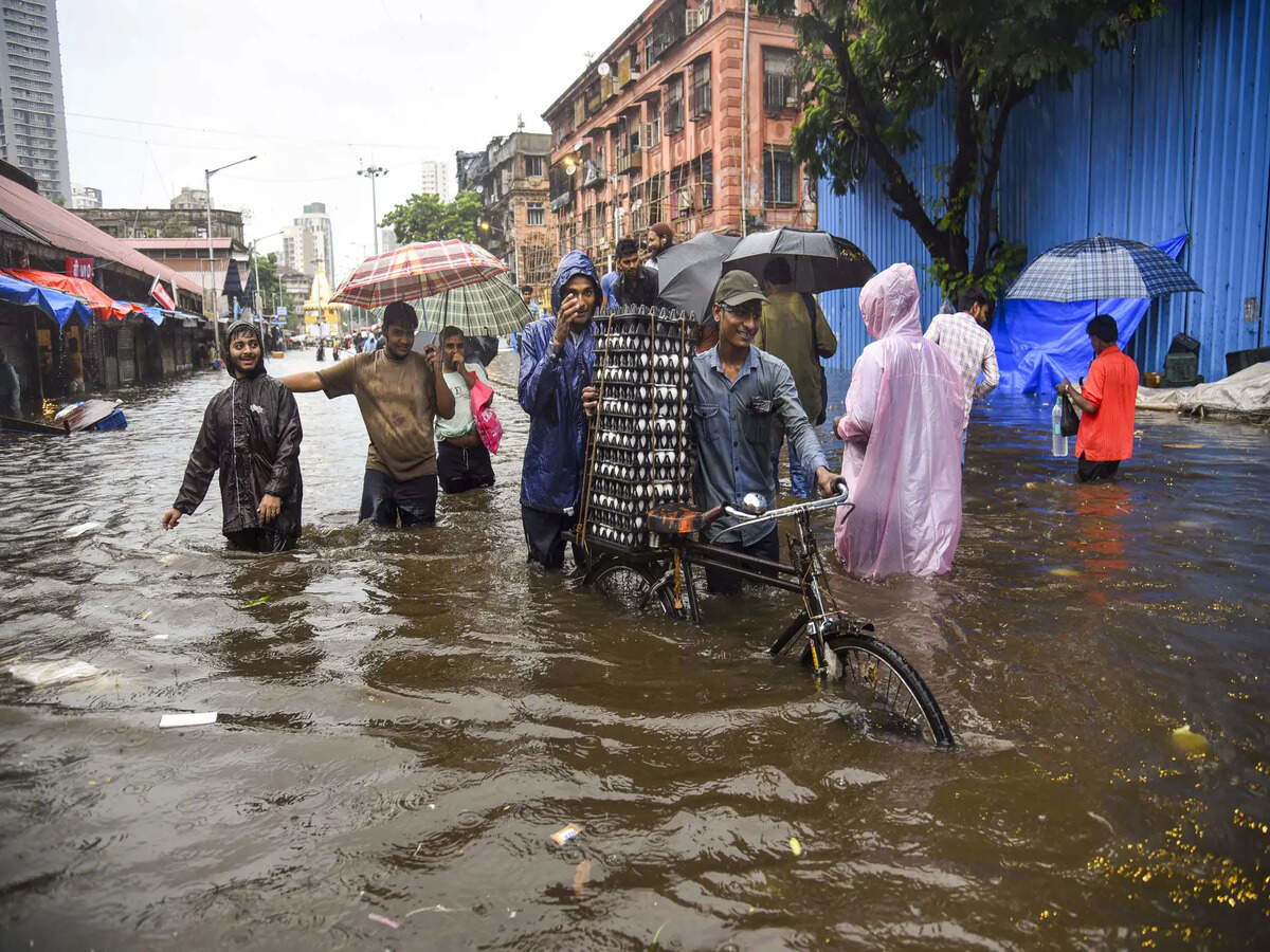 Severe flooding in Mumbai due to heavy monsoon rains leading to waterlogged streets and disruption of daily life during IMD red alert