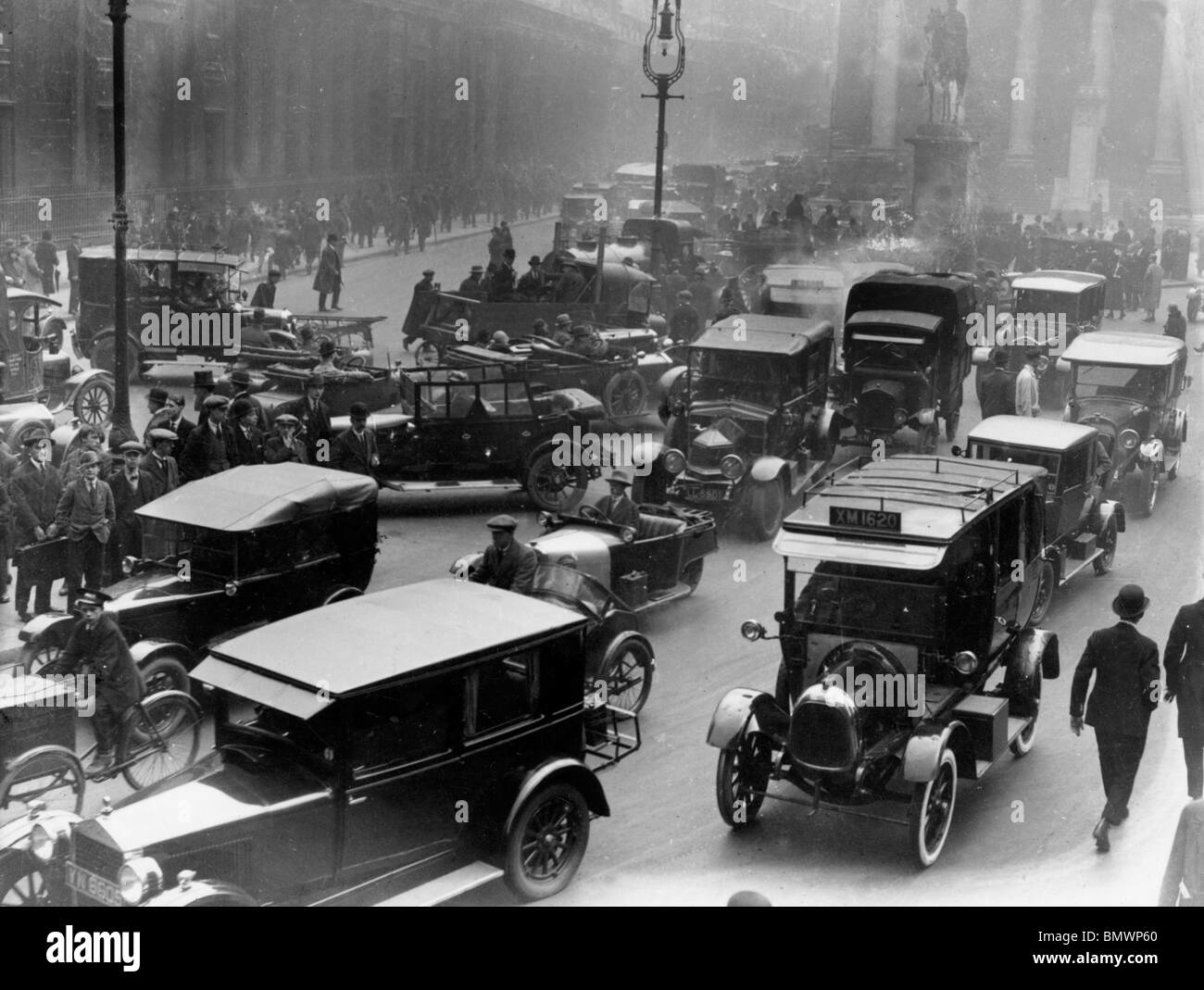 Busy London street scene in the 1920s showing early automobiles and pedestrians, capturing the urban atmosphere of the modernist period