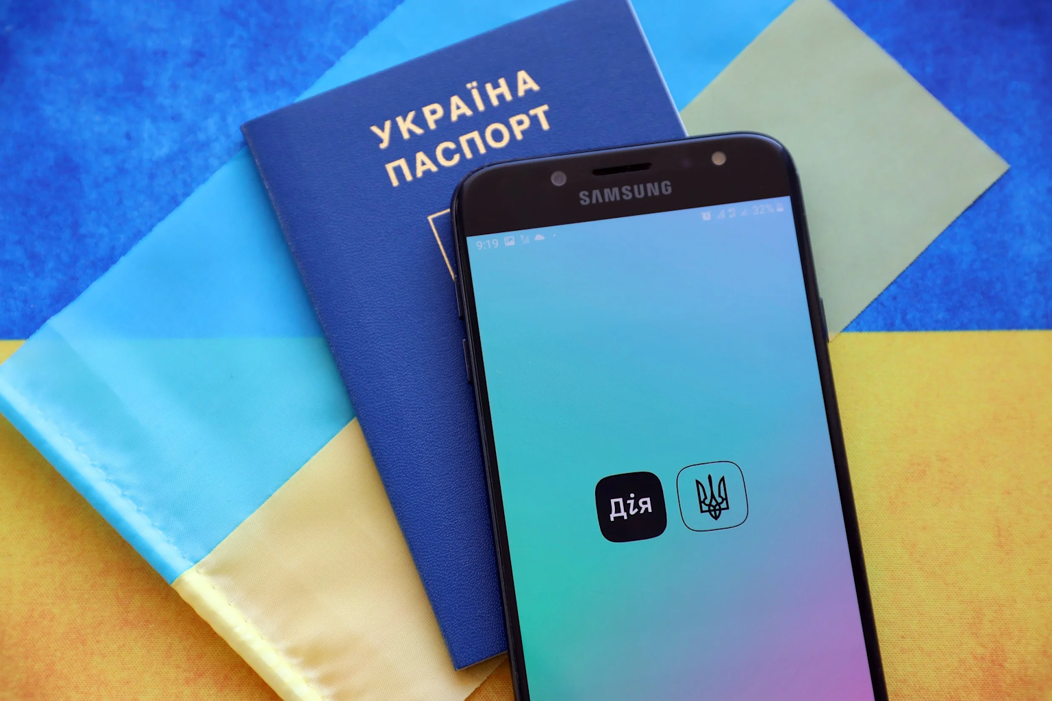A smartphone displaying Ukraine's government digital app with a Ukrainian passport and flag background