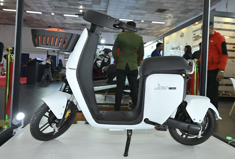 Modern electric scooter Joy E-Bike showcased at an exhibition, exemplifying EV two wheeler design and urban mobility