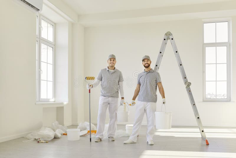 Professional carpenters with tools in bright, modern interior space