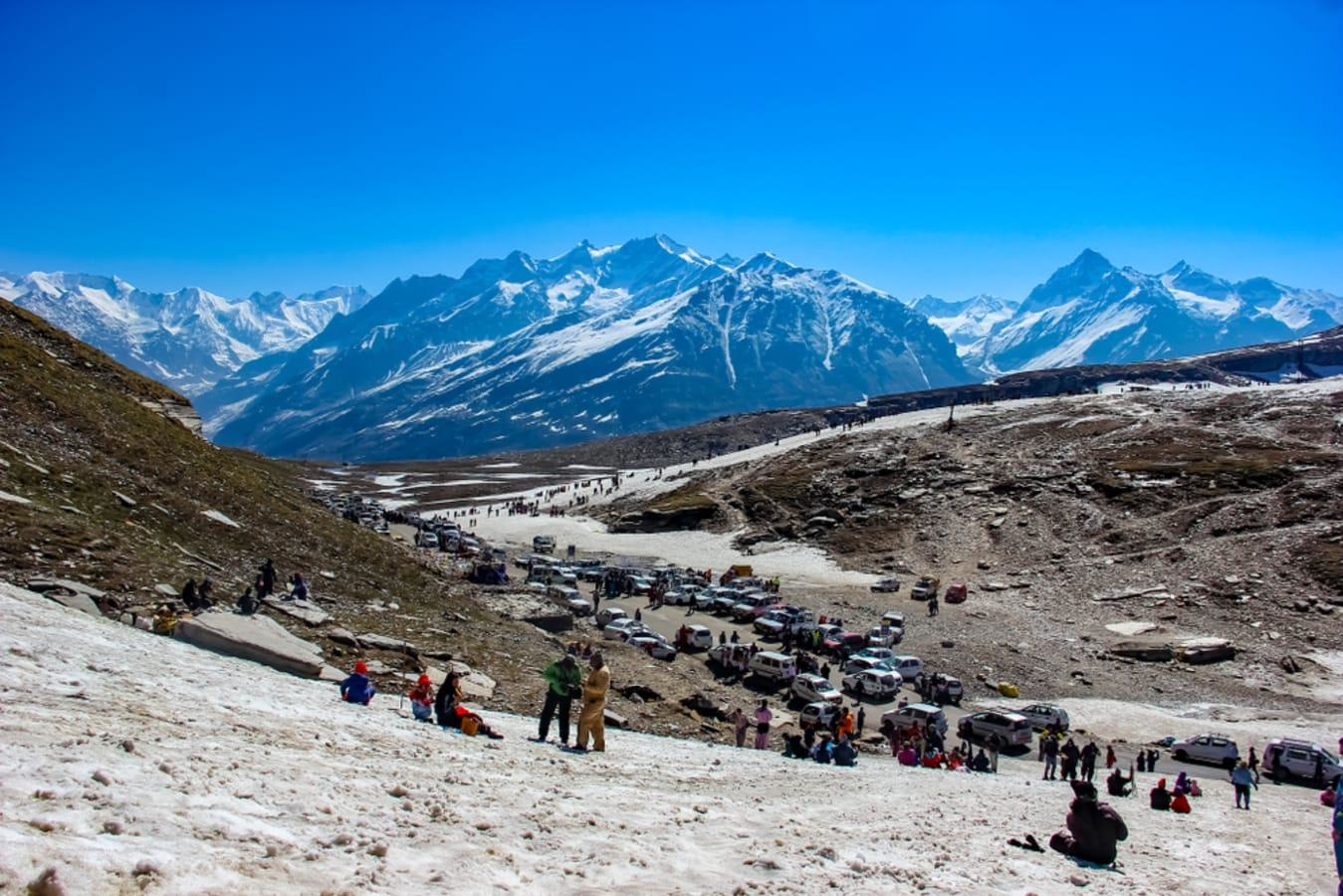 Tourists enjoying the snow-capped mountains and winter landscape at Rohtang Pass, Himachal Pradesh