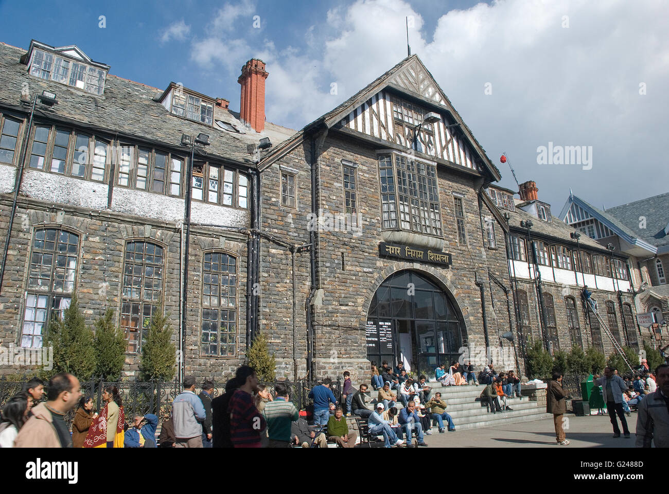Colonial-era stone building with arched windows and entry on Shimla Mall Road, reflecting British architectural influence